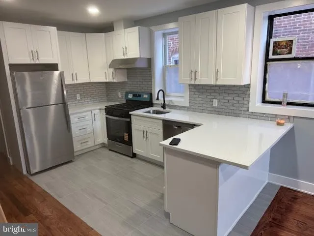 a kitchen with a sink a stove and refrigerator
