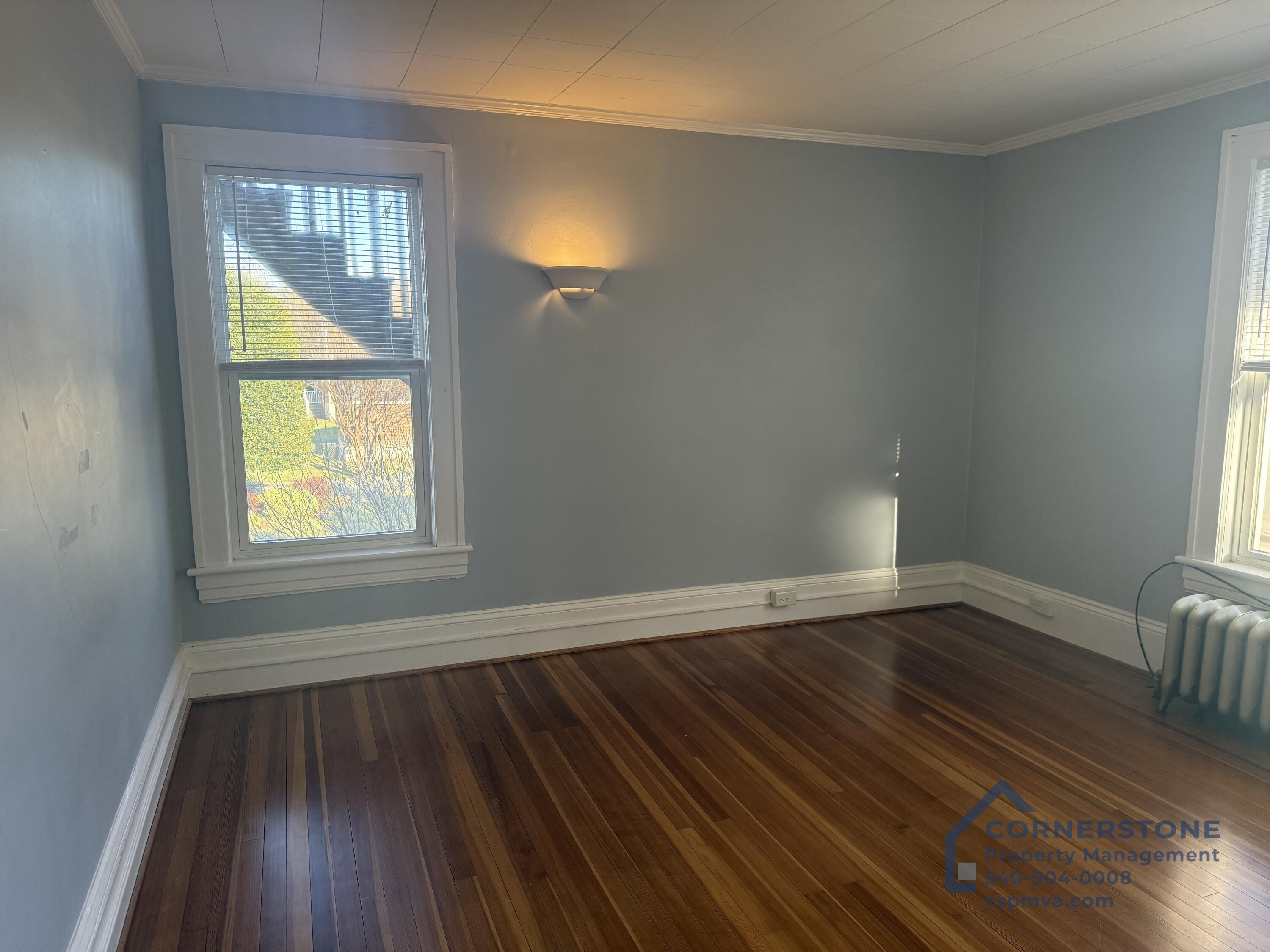 2423 Lofton Road Southwest, Unit 2 Roanoke, VA 24015 - Photo 6 of 14 a view of an empty room with wooden floor and a window