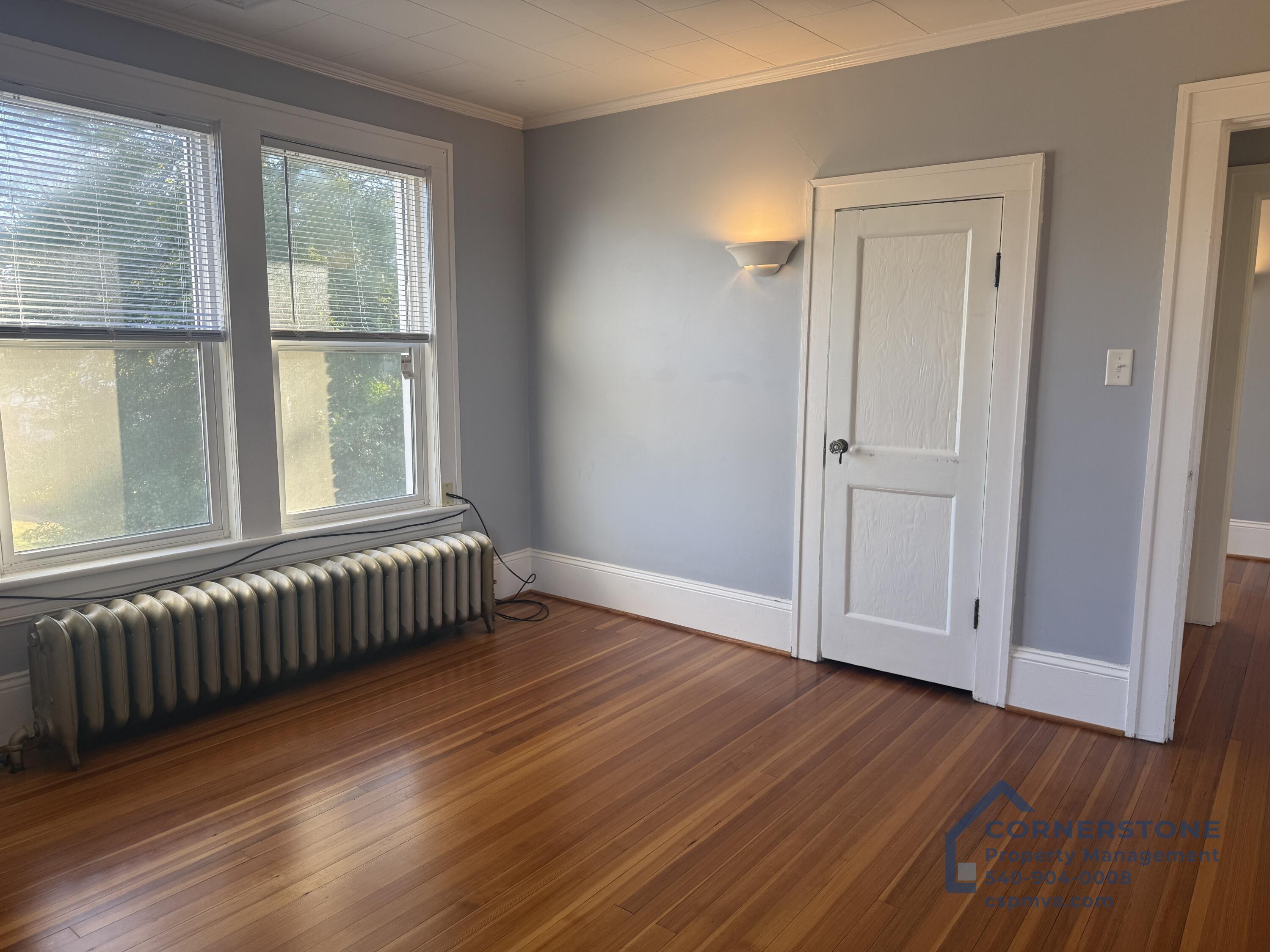 2423 Lofton Road Southwest, Unit 2 Roanoke, VA 24015 - Photo 7 of 14 a view of an empty room with wooden floor and a window