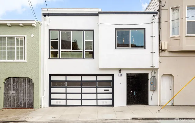 a front view of a house with large windows
