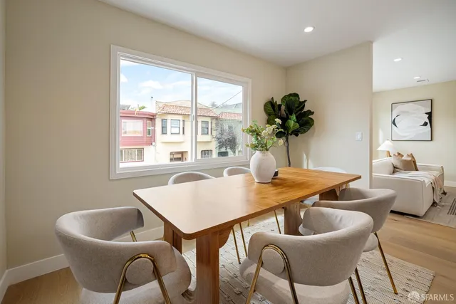 a dining room filled chandelier and kitchen view