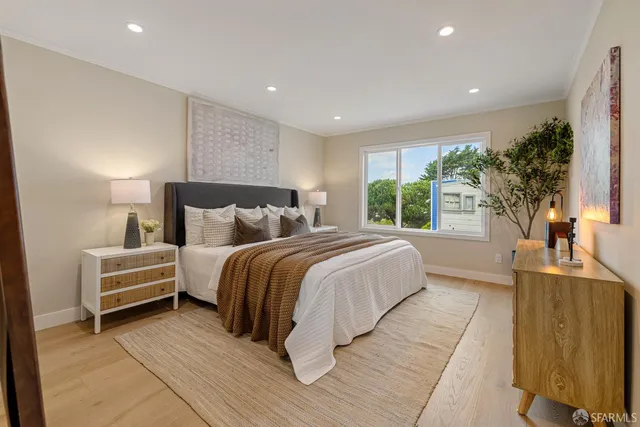 a bedroom with a bed and a painting on the wall