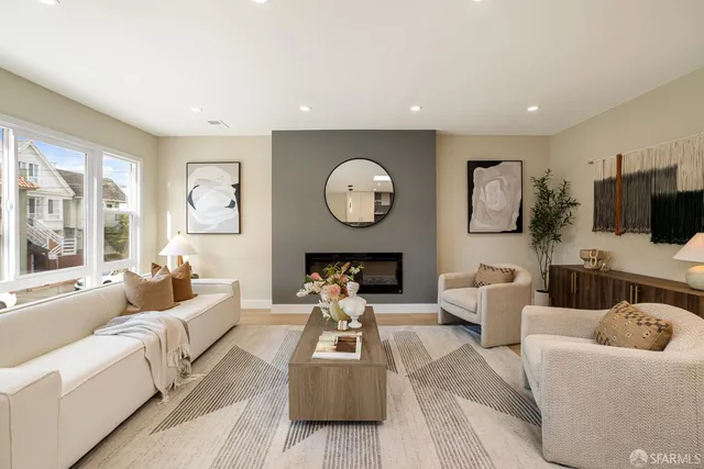 a living room with furniture a fireplace and a television
