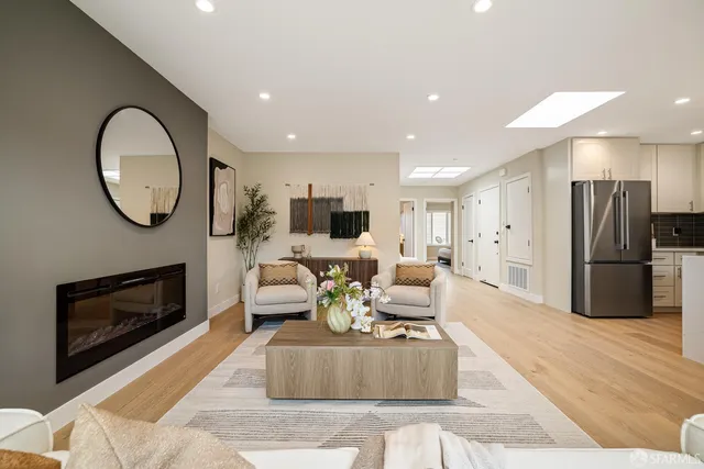 a living room with furniture and kitchen view