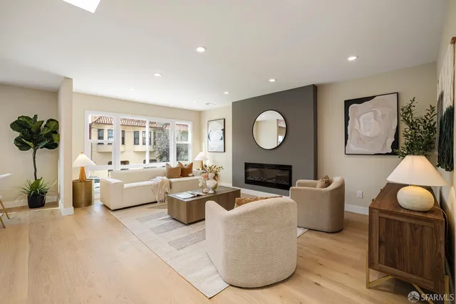 a living room with furniture a fireplace and a flat screen tv