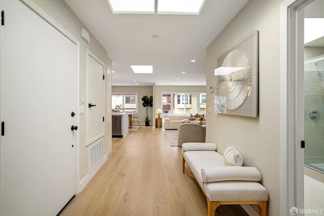 a living room with furniture a large window and a fireplace