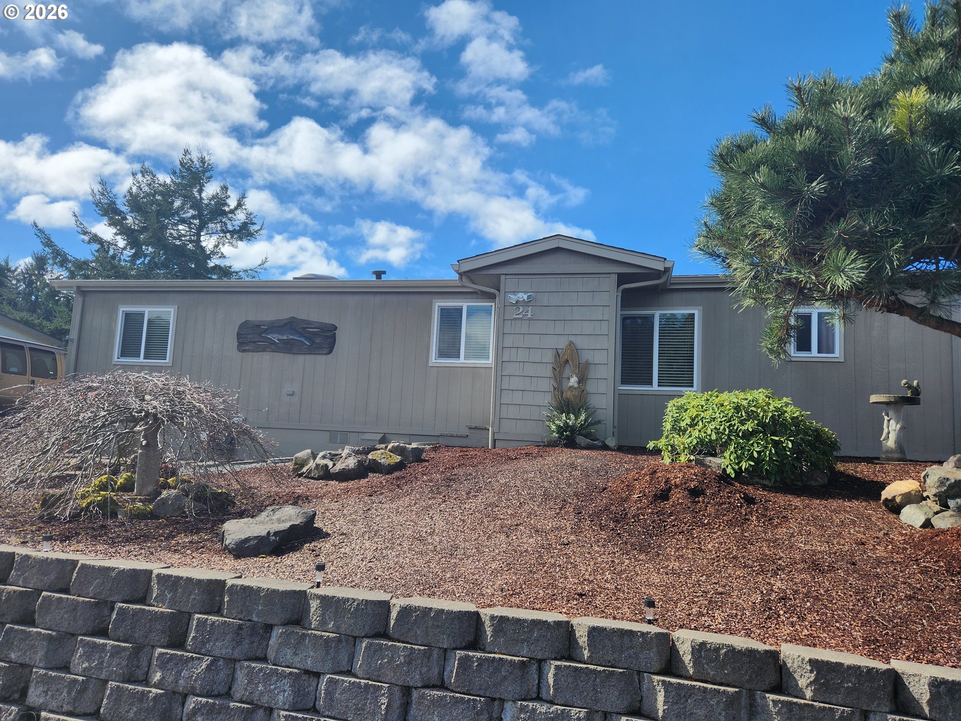 a backyard of a house with garden and barbeque oven