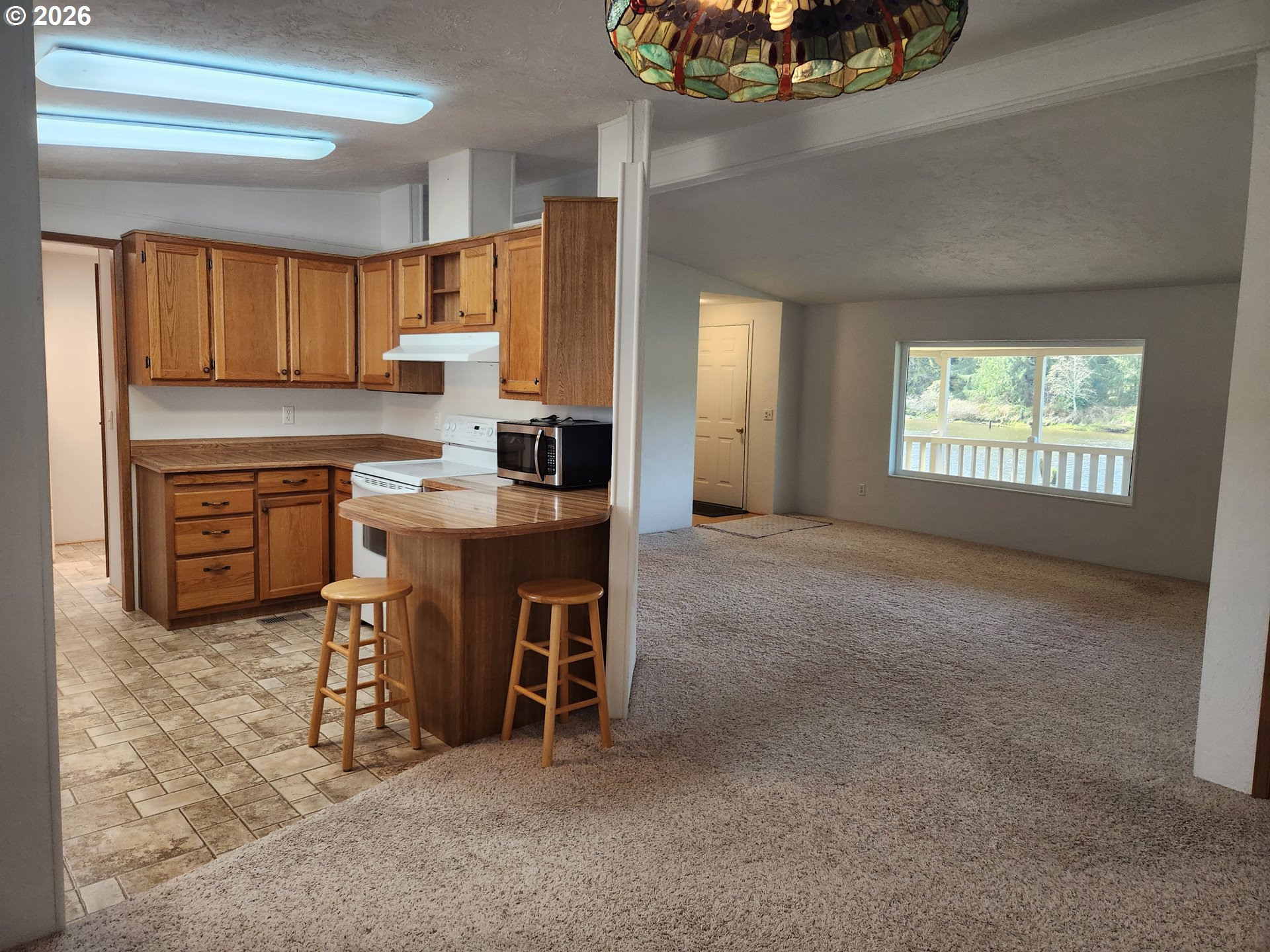 100 River Bend Road, Unit 24 Reedsport, OR 97467 - Photo 12 of 36 a view of a kitchen with a sink cabinets and a window