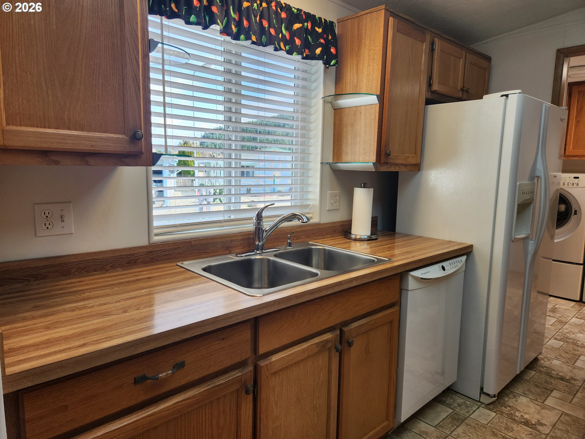 100 River Bend Road, Unit 24 Reedsport, OR 97467 - Photo 15 of 36 a kitchen with stainless steel appliances granite countertop a sink and a refrigerator