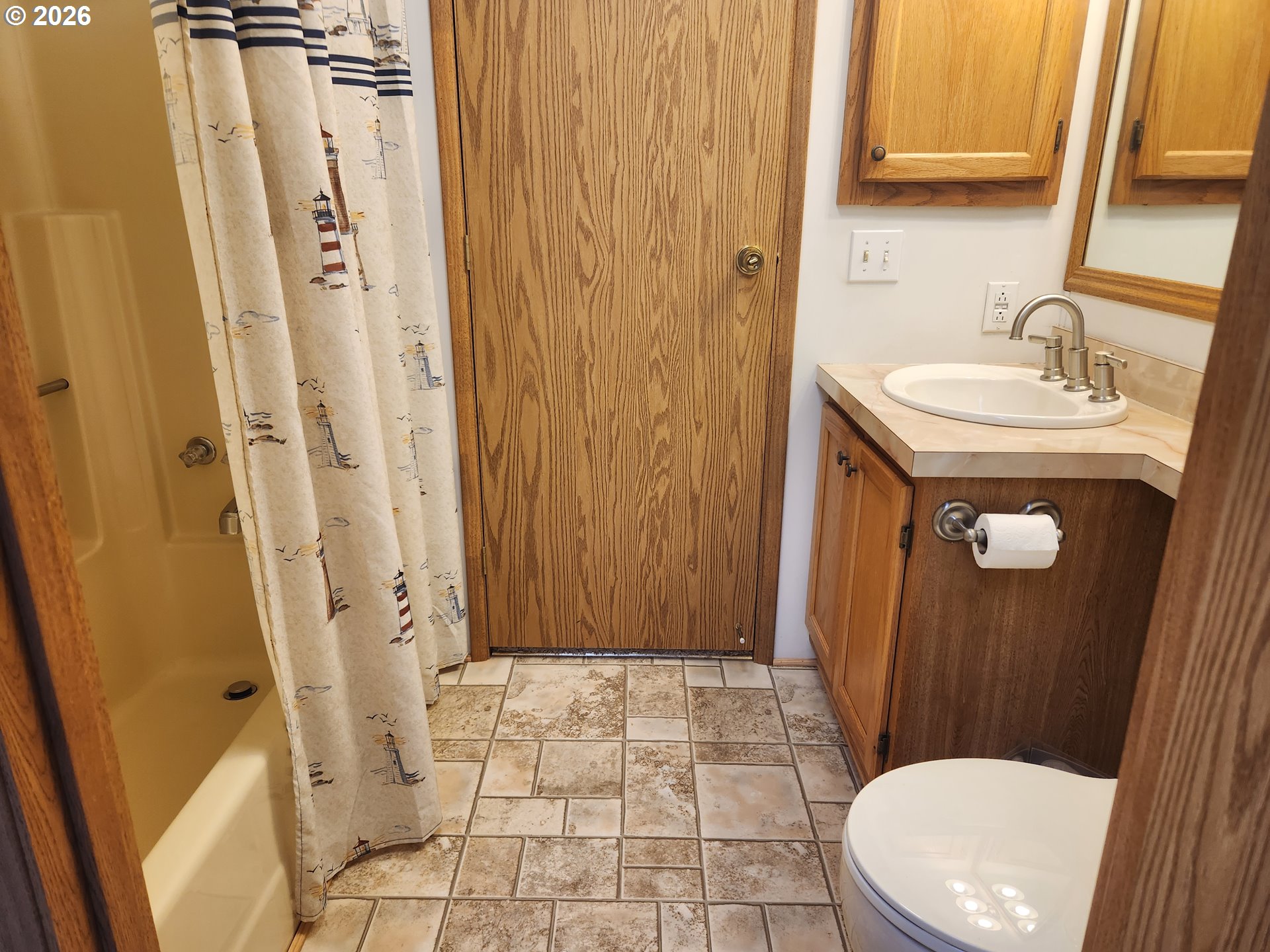 100 River Bend Road, Unit 24 Reedsport, OR 97467 - Photo 30 of 36 a bathroom with a sink a toilet a mirror and shower