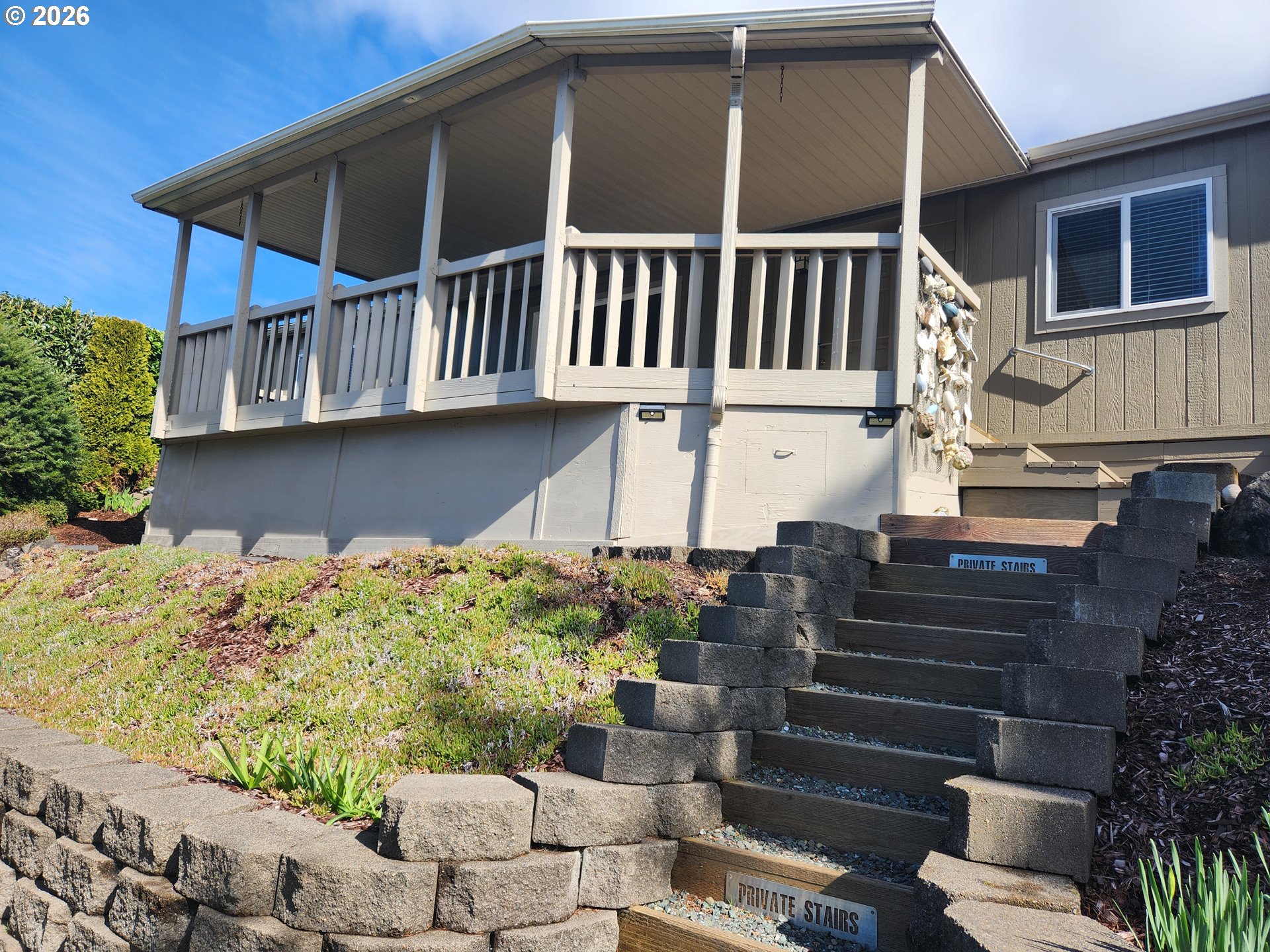 100 River Bend Road, Unit 24 Reedsport, OR 97467 - Photo 6 of 36 a front view of a house with a yard
