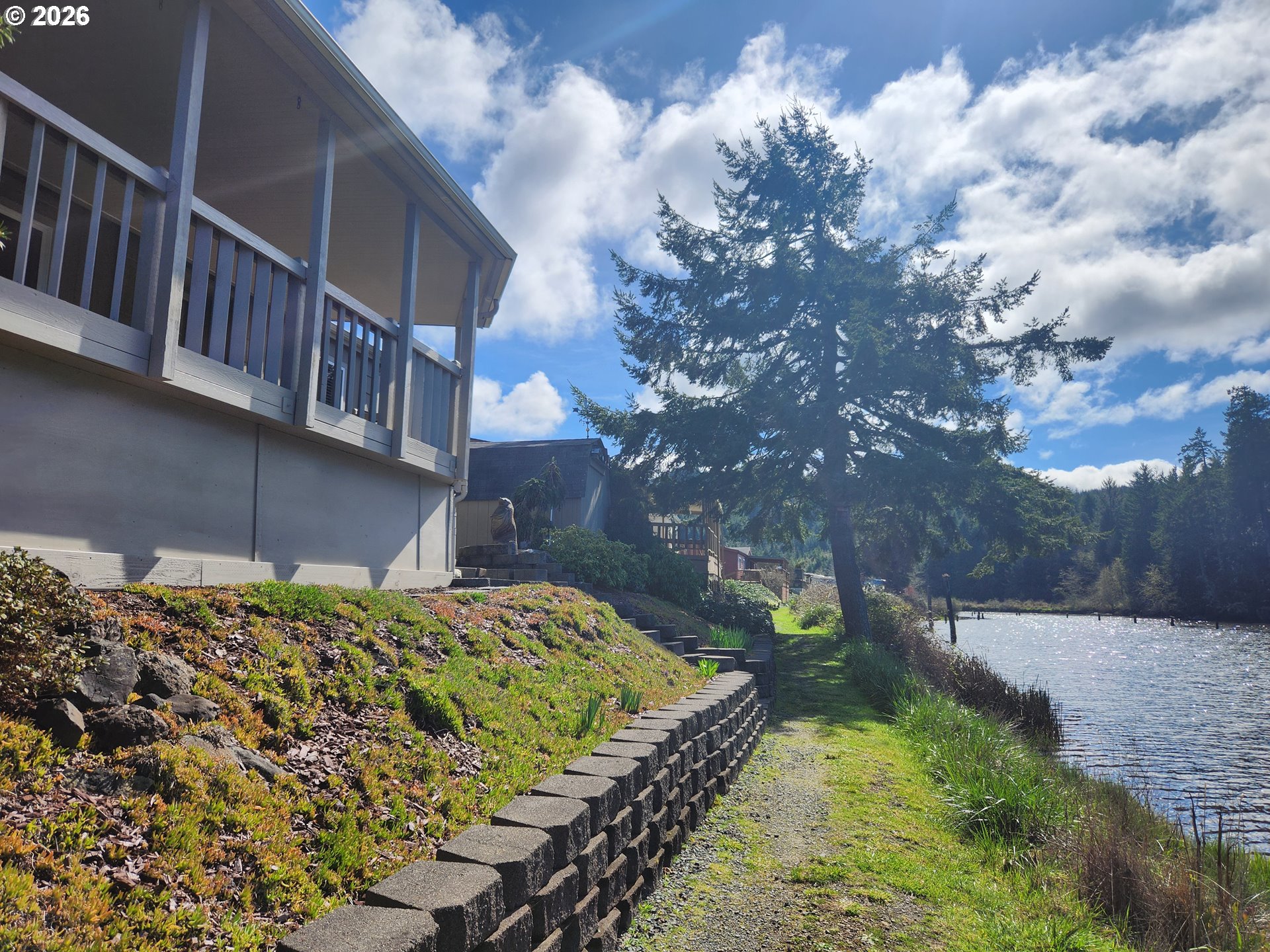 100 River Bend Road, Unit 24 Reedsport, OR 97467 - Photo 7 of 36 a backyard of a house with lots of green space