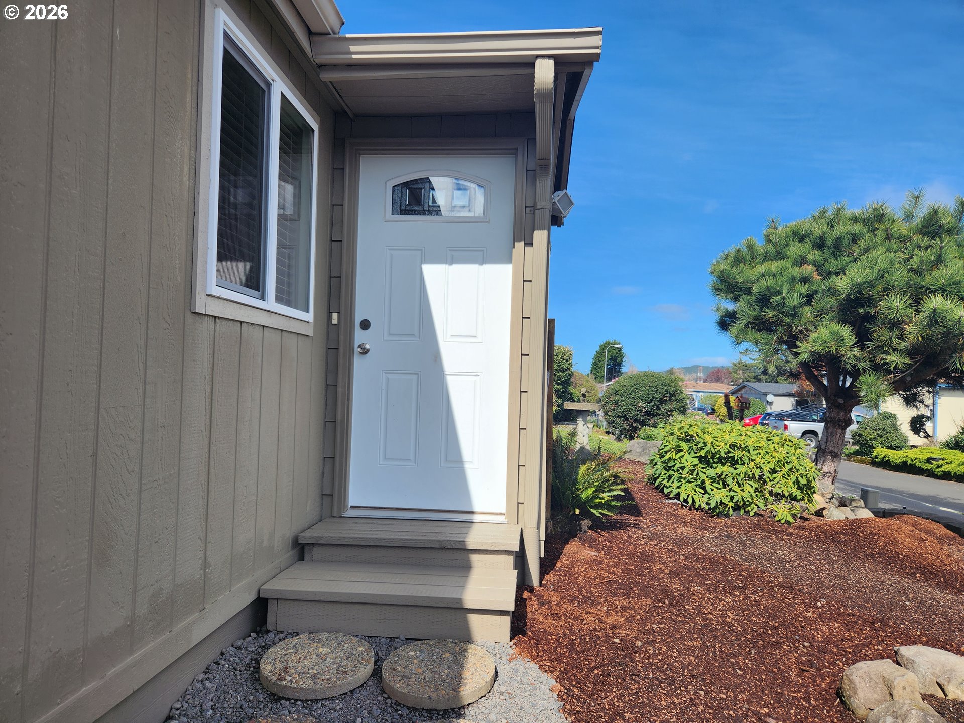 100 River Bend Road, Unit 24 Reedsport, OR 97467 - Photo 10 of 36 a front view of a house with a yard