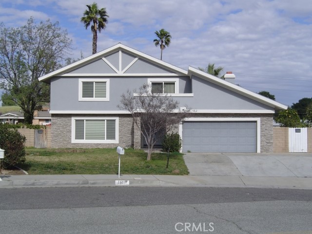 11217 Springfield Street Riverside, CA 92505 - Photo 1 of 1 a front view of a house with a yard and garage