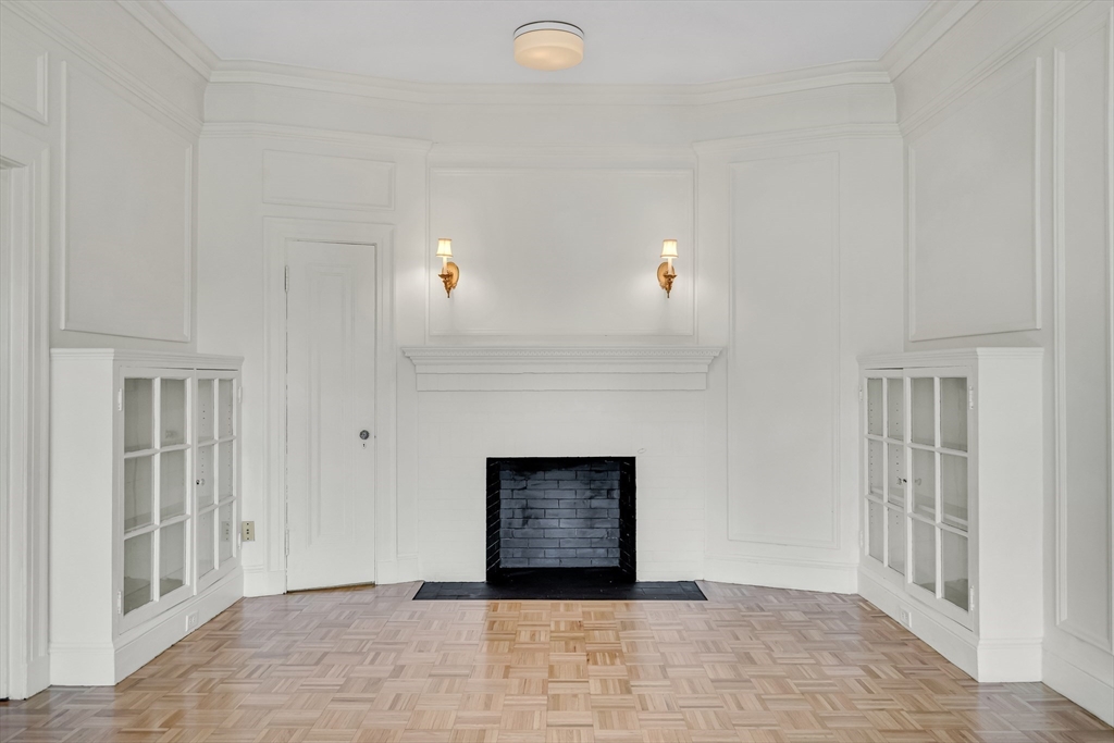311 Commonwealth Avenue, Unit 71 Boston, MA 02115 - Photo 3 of 19 a view of an empty room with a fireplace