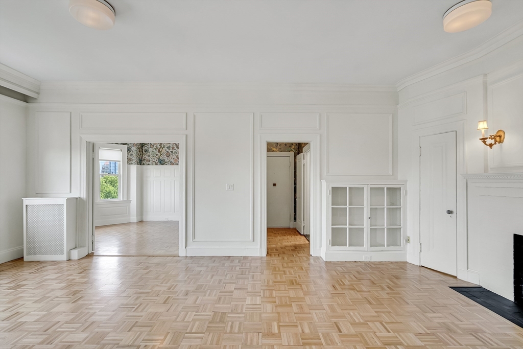 311 Commonwealth Avenue, Unit 71 Boston, MA 02115 - Photo 4 of 19 wooden floor in an empty room with a window