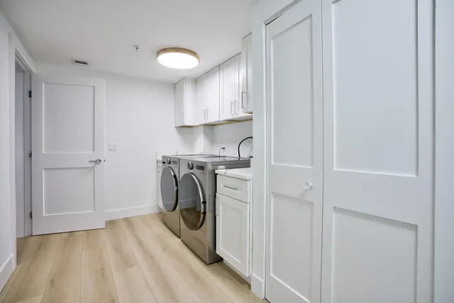 a view of a storage and utility room with washer and dryer