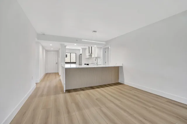 a view of kitchen with wooden floor and window