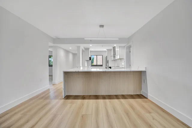 a view of kitchen with granite countertop cabinets and wooden floor
