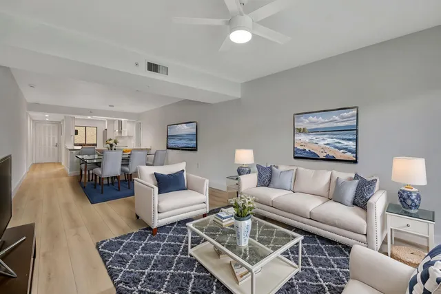 a living room with furniture a rug and a lamp