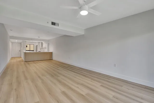 a view of wooden floor and windows in a room