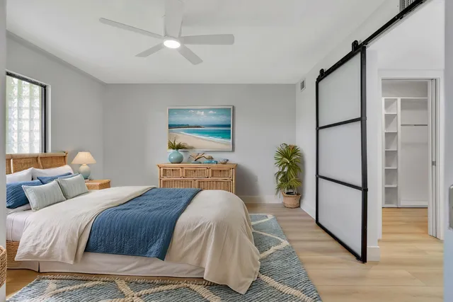 a bedroom with a bed and a potted plant