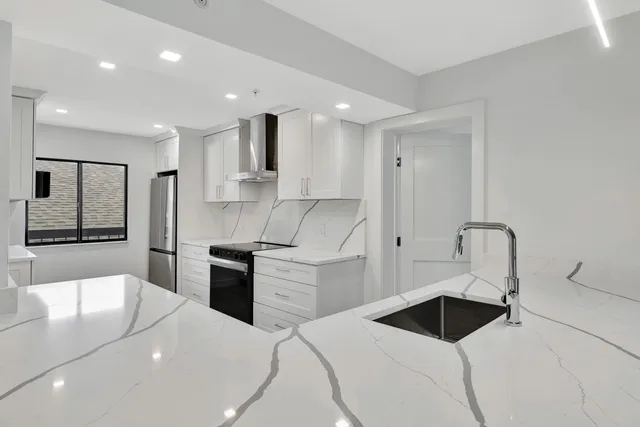 a kitchen with a stove a sink and a refrigerator