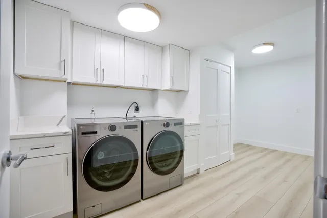a utility room with sink dryer and washer
