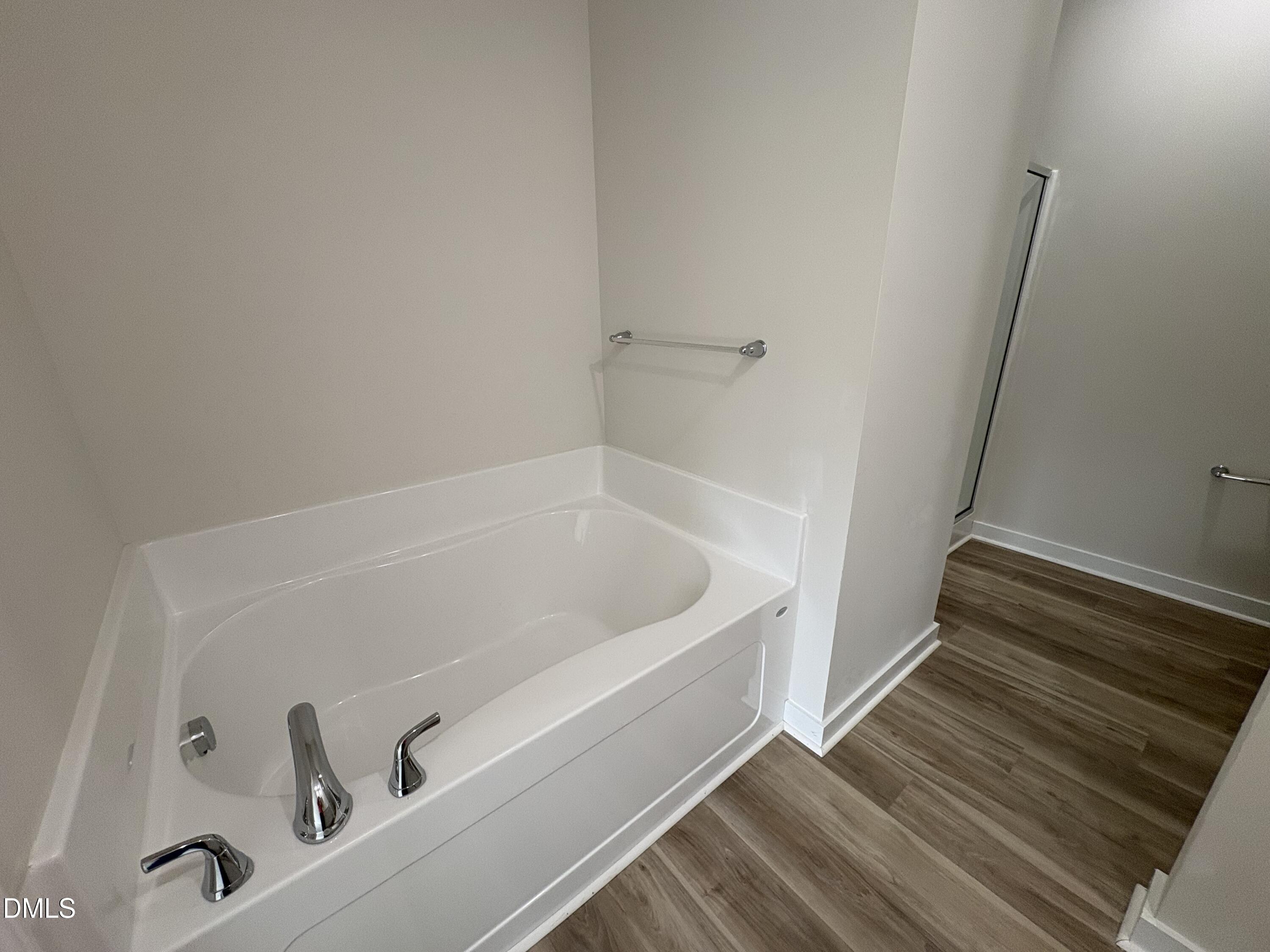 253 Jacobs Ridge Drive Four Oaks, NC 27524 - Photo 11 of 17 a bath tub sitting next to a white sink