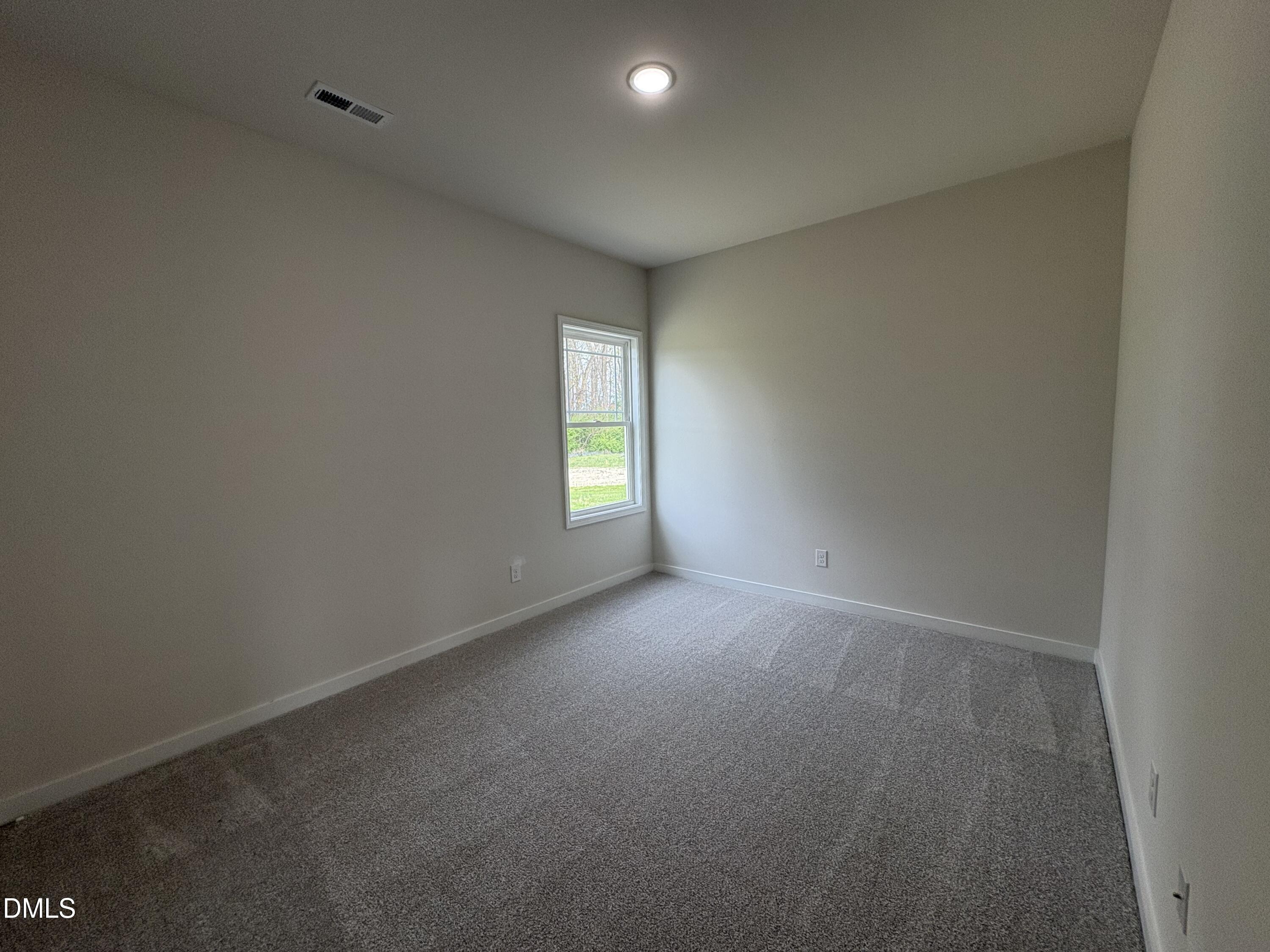 253 Jacobs Ridge Drive Four Oaks, NC 27524 - Photo 14 of 17 a view of an empty room with a window
