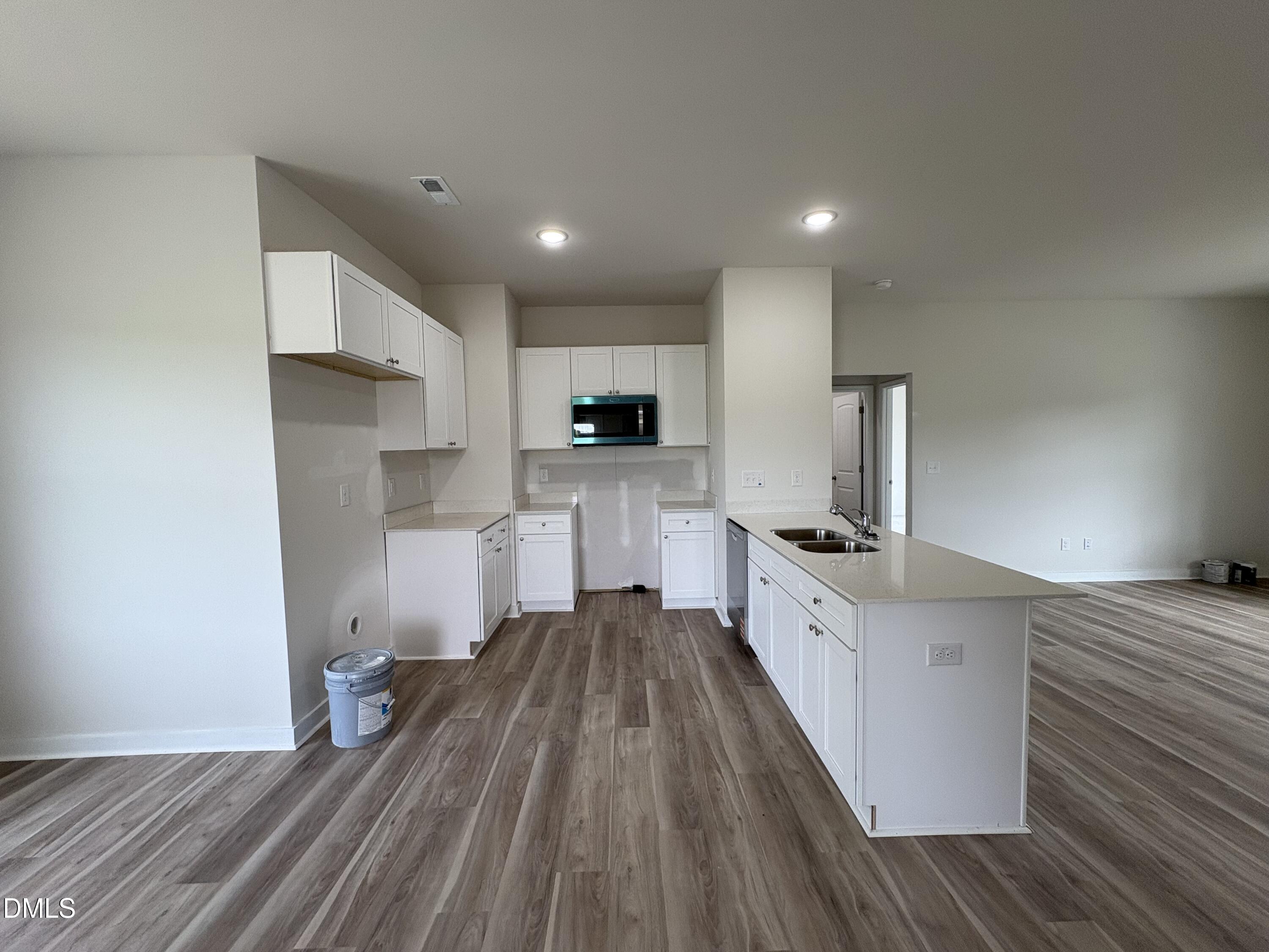 253 Jacobs Ridge Drive Four Oaks, NC 27524 - Photo 5 of 17 a large kitchen with a lot of counter space and wooden floor