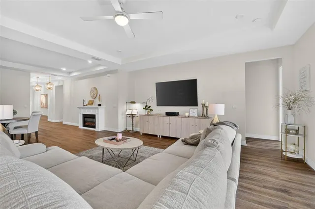 a large kitchen with kitchen island a stove a sink a center island and a wooden floor