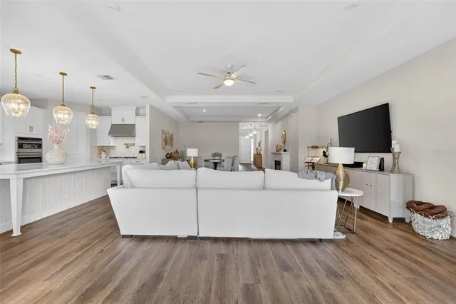 a kitchen with stainless steel appliances kitchen island granite countertop a stove a sink and a wooden floors