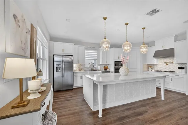 a spacious bedroom with a bed and a large window