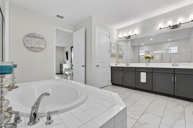 a kitchen with stainless steel appliances granite countertop a sink dishwasher and cabinets with wooden floor