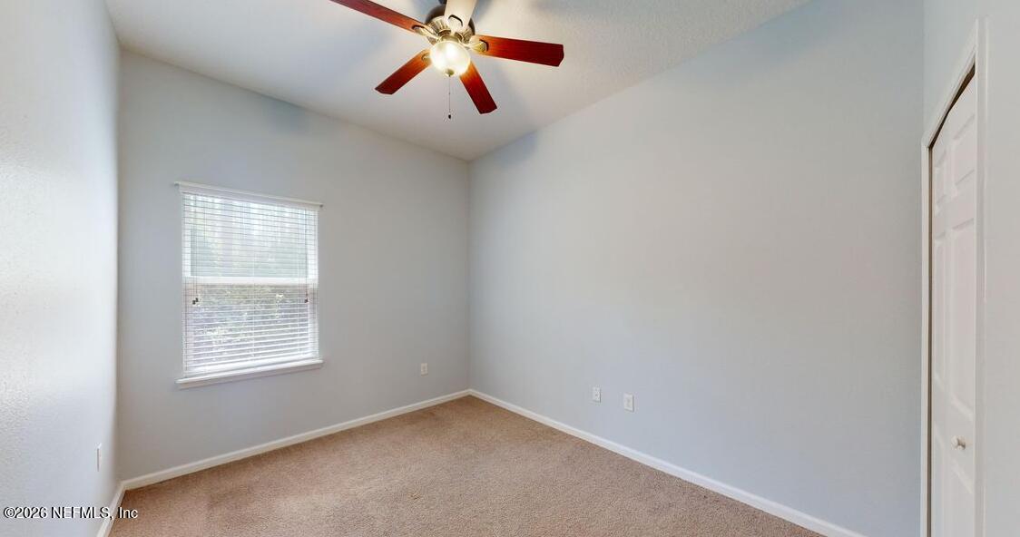 224 Larkin Place, Unit 103 St. Johns, FL 32259 - Photo 11 of 20 an empty room with windows and fan