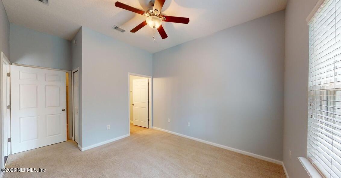 224 Larkin Place, Unit 103 St. Johns, FL 32259 - Photo 14 of 20 an empty room with windows and fan