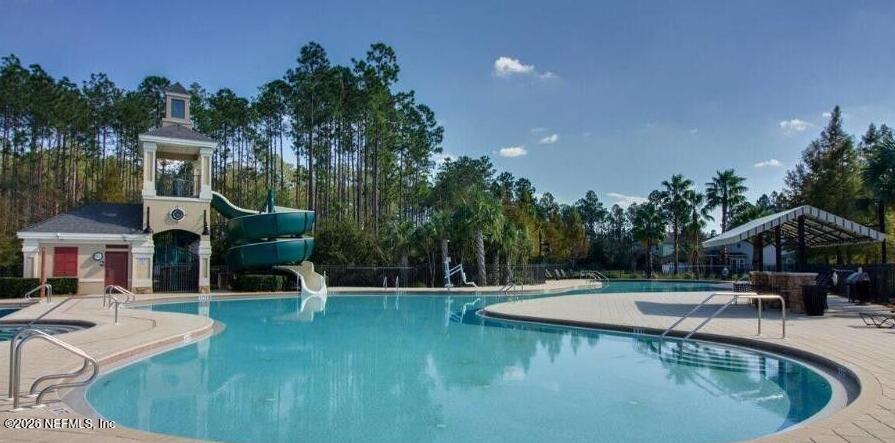224 Larkin Place, Unit 103 St. Johns, FL 32259 - Photo 19 of 20 a view of a swimming pool with a bench and trees around