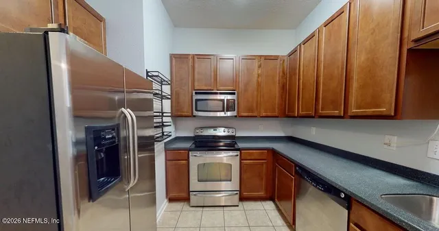 a kitchen with a sink and stainless steel appliances