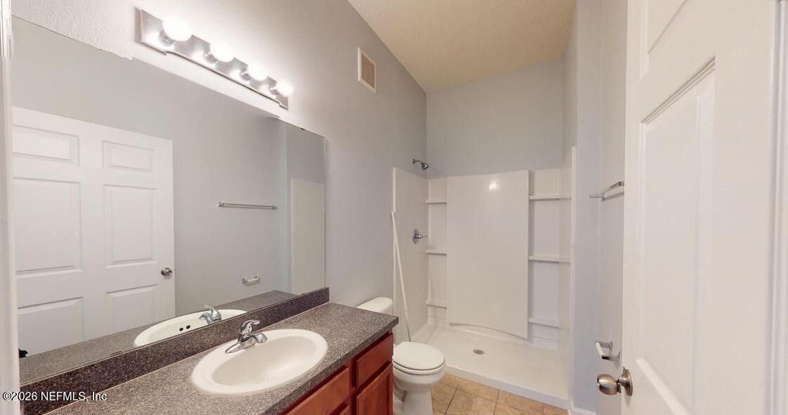 224 Larkin Place, Unit 103 St. Johns, FL 32259 - Photo 10 of 20 a bathroom with a sink double vanity granite tub and shower