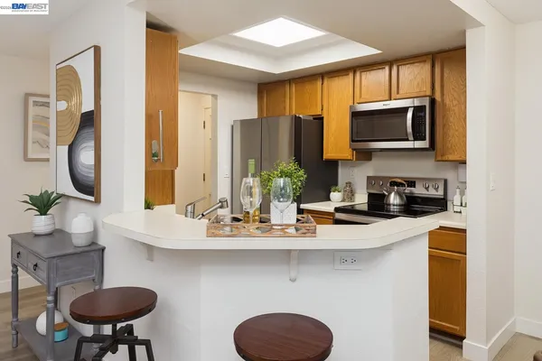 a kitchen with stainless steel appliances granite countertop a sink and a microwave