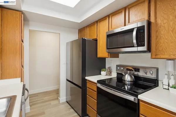 a kitchen with stainless steel appliances granite countertop a refrigerator stove and microwave