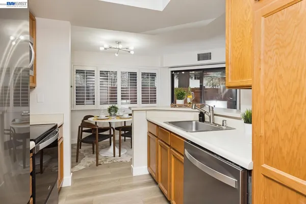 a kitchen with a sink stove and cabinets