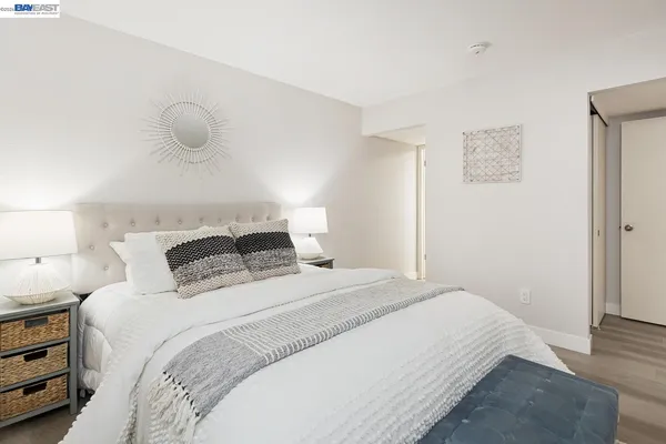 a bedroom with a bed and a painting on the wall