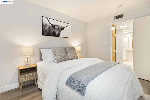 a bedroom with a bed and a painting