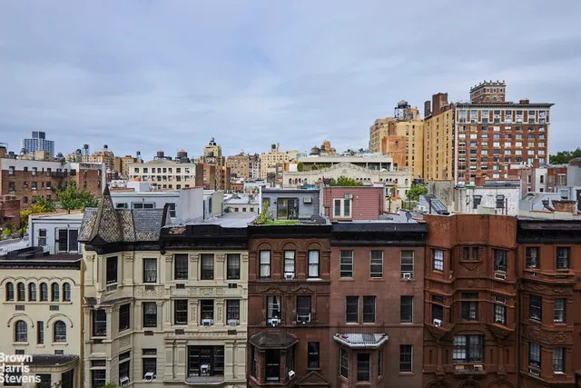 a kitchen with granite countertop a stove top oven microwave and refrigerator