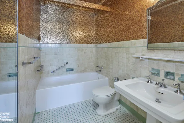 a view of a hallway with wooden floor and a living room