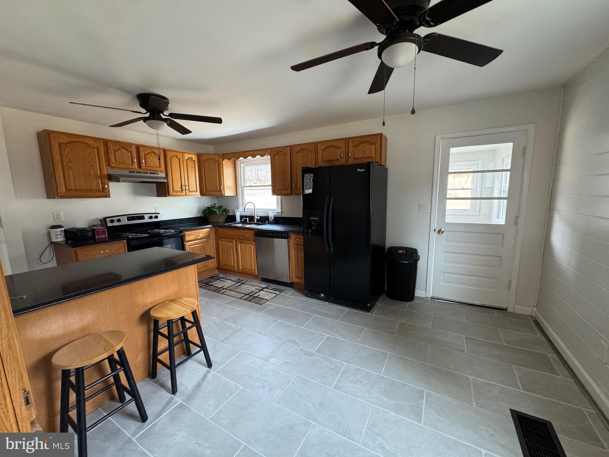 18712 Crossland Road Southwest Rawlings, MD 21557 - Photo 49 of 89 a kitchen with stainless steel appliances granite countertop a refrigerator a sink a stove and microwave