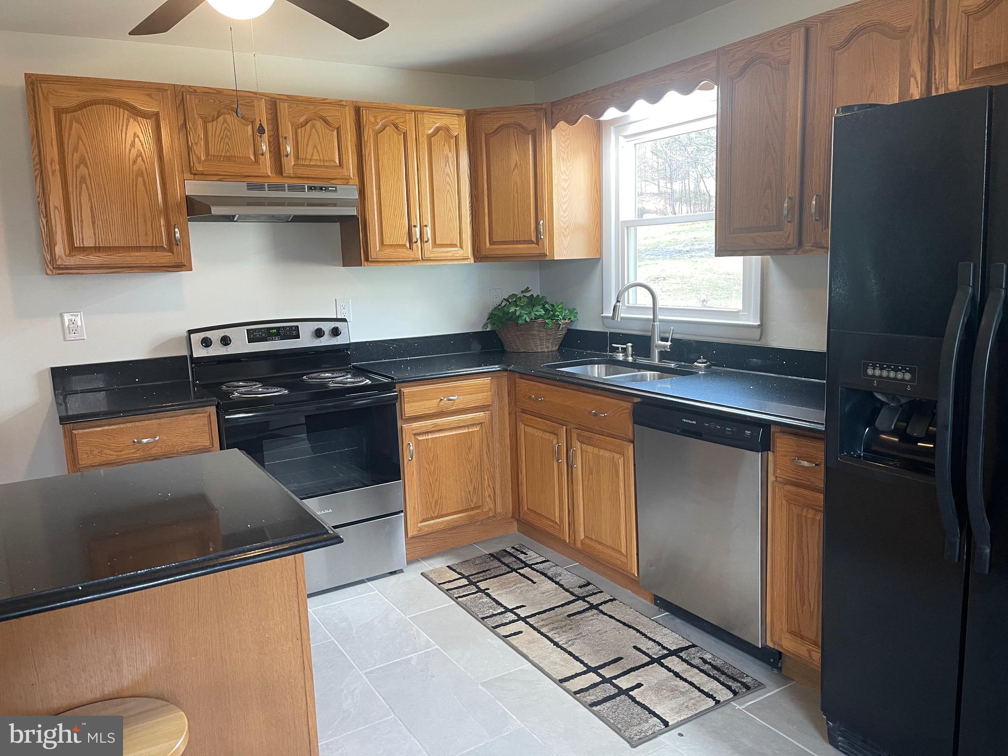 18712 Crossland Road Southwest Rawlings, MD 21557 - Photo 50 of 89 a kitchen with stainless steel appliances granite countertop a stove a sink and a refrigerator