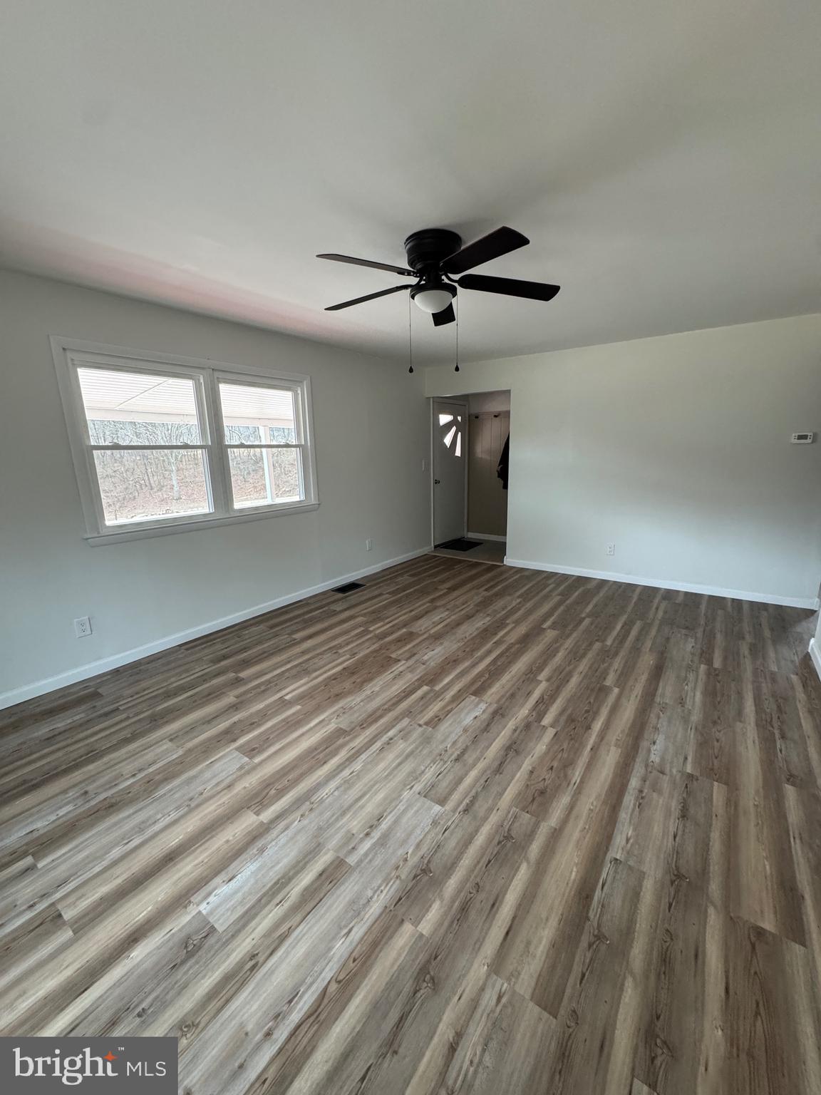 18712 Crossland Road Southwest Rawlings, MD 21557 - Photo 58 of 89 wooden floor in an empty room with a window